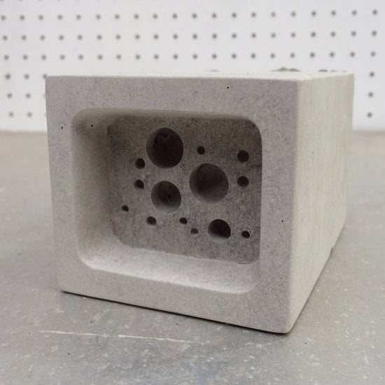 small bee block against pegboard background