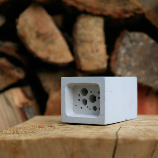 small bee block against wood pile