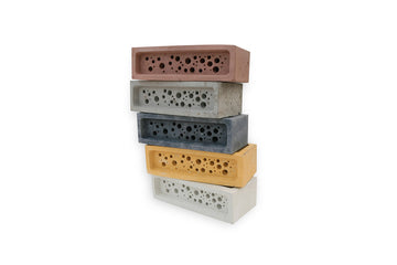 stack of coloured bee brick solitary bee houses