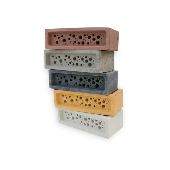 Stack of coloured bee brick bee houses