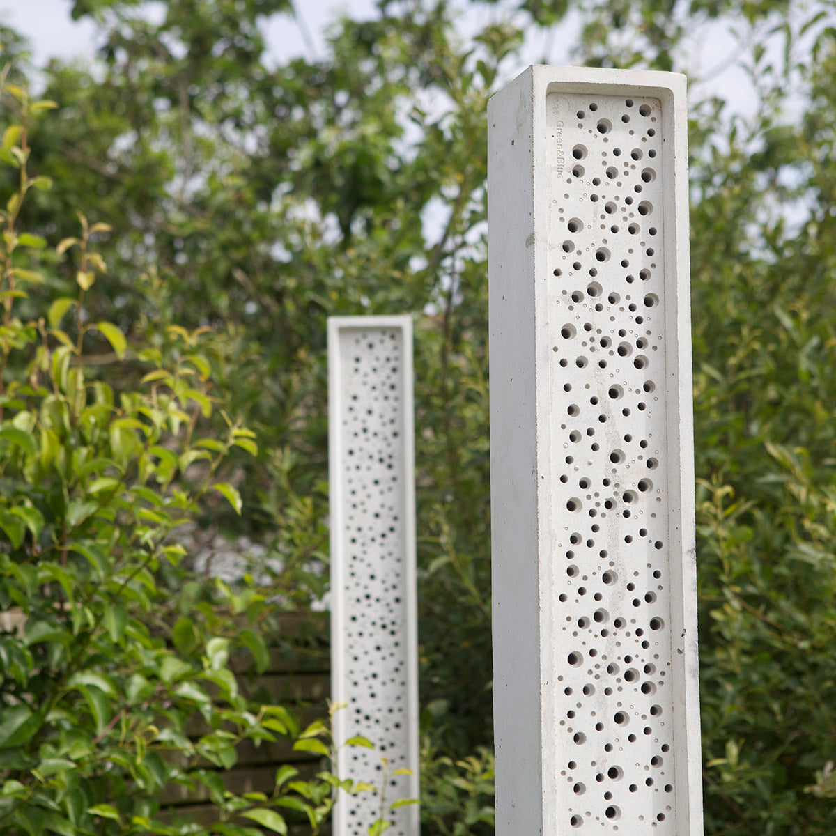 stylish bee post bee towers in wildflower garden