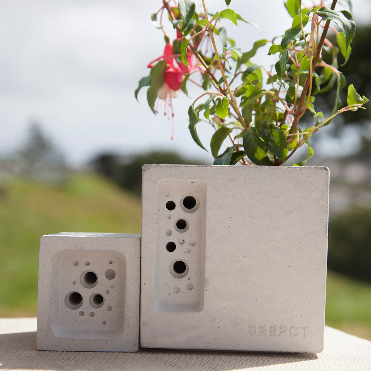 concrete bee hotel beepot mini shown with a small bee block